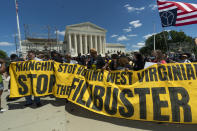 Protesters hold banners as they march from the U.S. Supreme Court, to the Hart Senate Office building in Washington, Wednesday, June 23, 2021, announcing a "Moral March on Manchin and McConnell" and highlighting the right to vote and living wages. (AP Photo/Manuel Balce Ceneta)