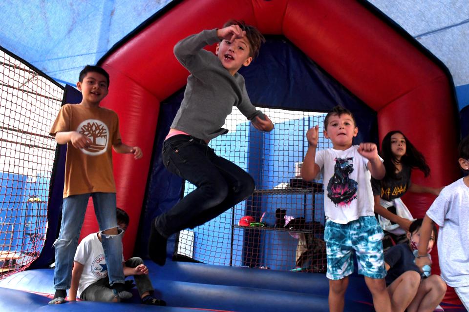 Sebastian Delacruz, from left, Phoenix Avila, Elijah Holden and Phoebe Avila jump in a bounce house Friday as the facility expands in other parts of the Boys & Girls Club of Camarillo.