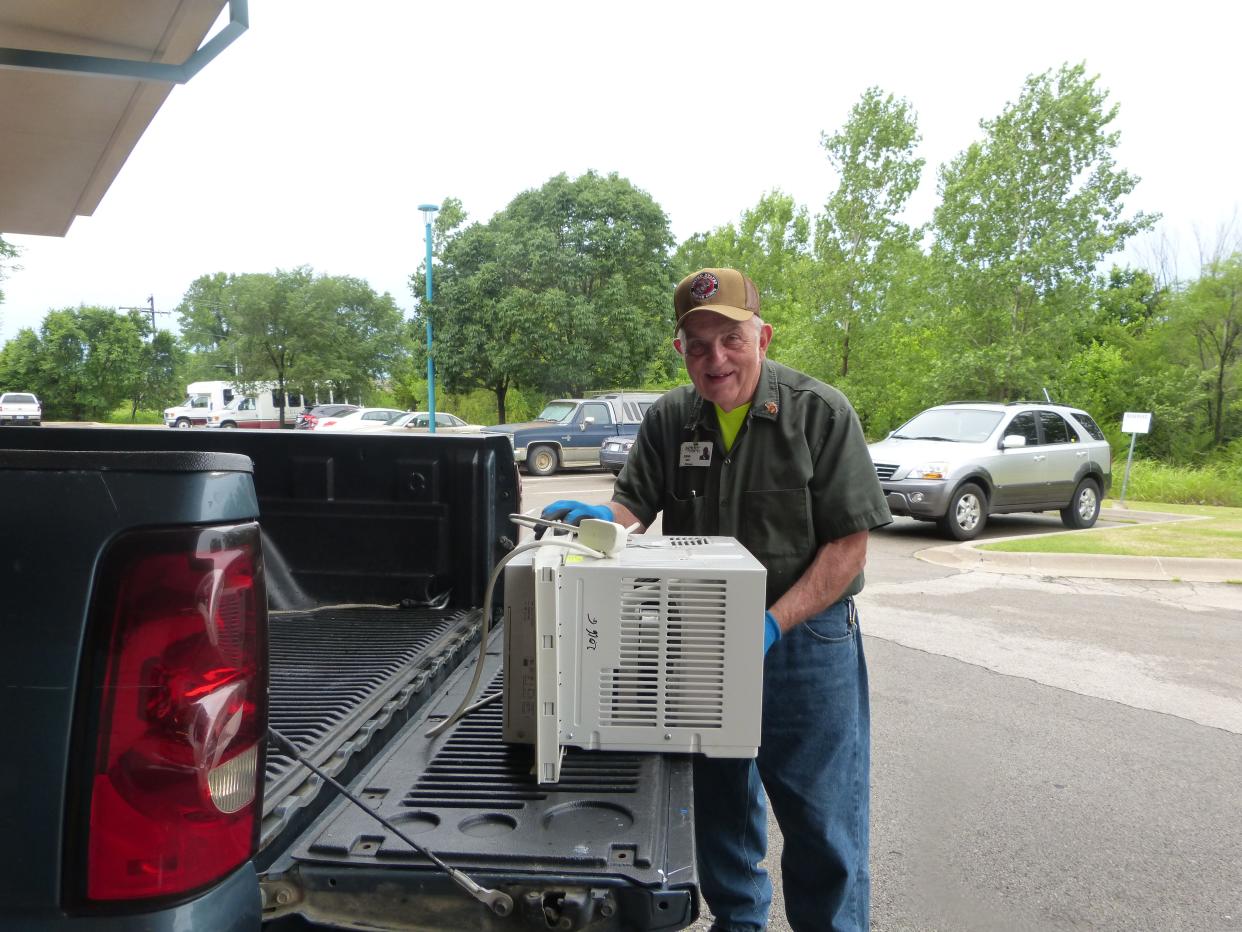 John Scott, with Elder Care, prepares to deliver and set up an air conditioner for a senior in need last summer.