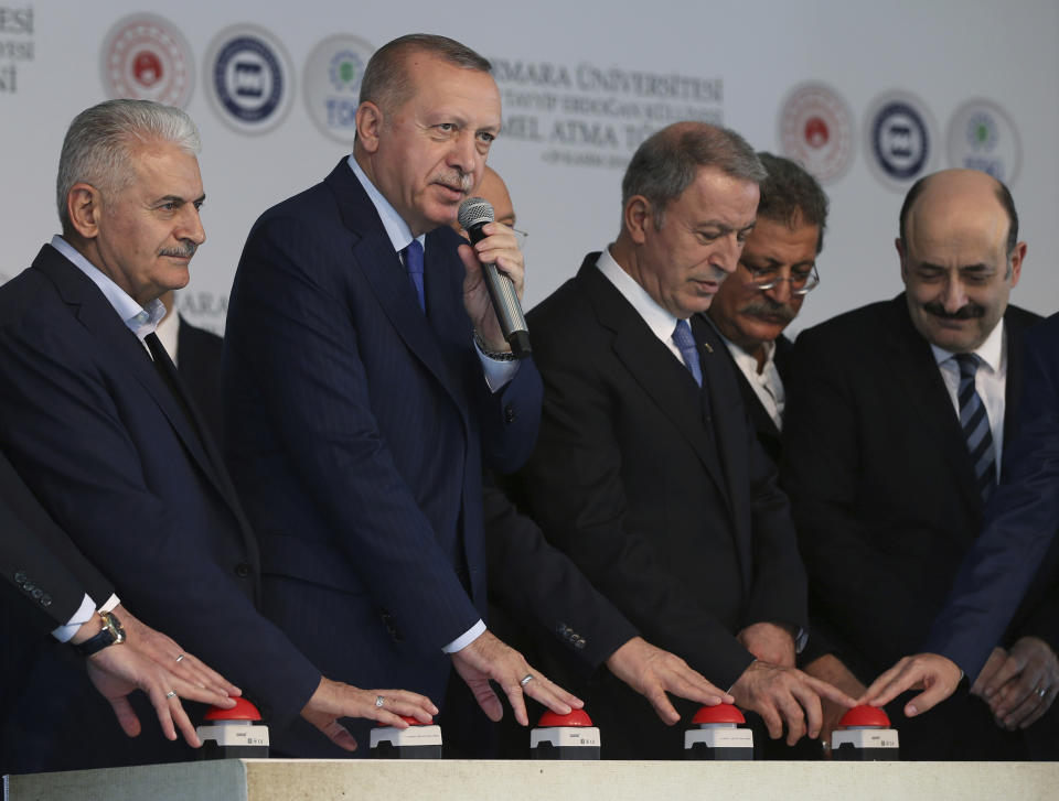 Turkey's President Recep Tayyip Erdogan, second left, speaks during the ground-breaking of Marmara University's Recep Tayyip Erdogan complex, in Istanbul, Friday, Nov. 29, 2019. Erdogan slammed French President Emmanuel Macron Friday for his comments on NATO and Turkey's membership. "You should get checked whether you're brain-dead," Erdogan called out to Macron.( Presidential Press Service via AP, Pool ) .