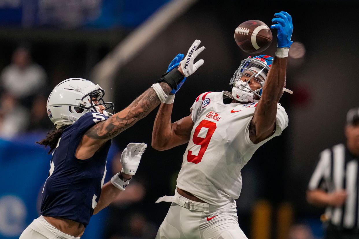 Dec 30, 2023; Atlanta, GA, USA; Mississippi Rebels wide receiver Tre Harris (9) tries for a catch against Penn State Nittany Lions cornerback Cam Miller (5) during the second half at Mercedes-Benz Stadium. Mandatory Credit: Dale Zanine-USA TODAY Sports