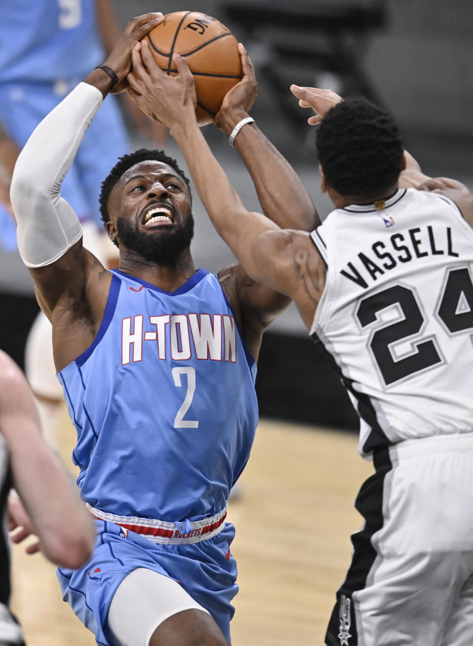 Houston Rockets' David Nwaba (2) attempts to shoot against San Antonio Spurs' Devin Vassell during the second half of an NBA basketball game, Saturday, Jan. 16, 2021, in San Antonio. (AP Photo/Darren Abate)