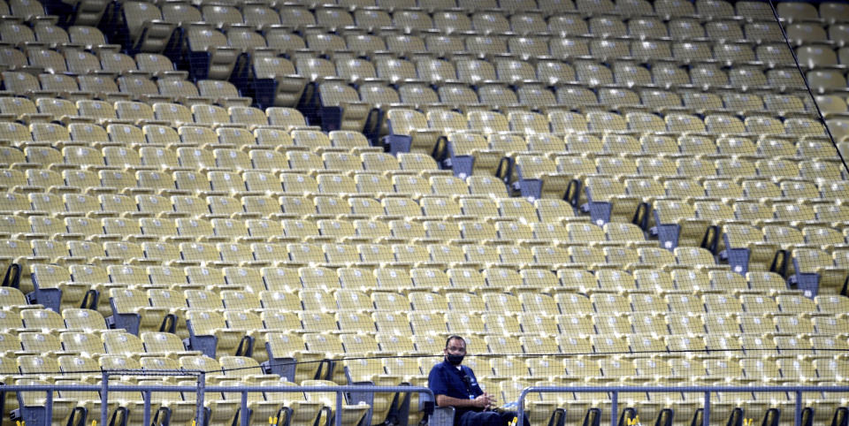 Los Angeles Dodgers security sits by himself in the third inning of a MLB baseball game between the Los Angeles Dodgers and the Oakland Athletics at Dodger Stadium in Los Angeles on Wednesday, September 23, 2020. (Keith Birmingham/The Orange County Register via AP)
