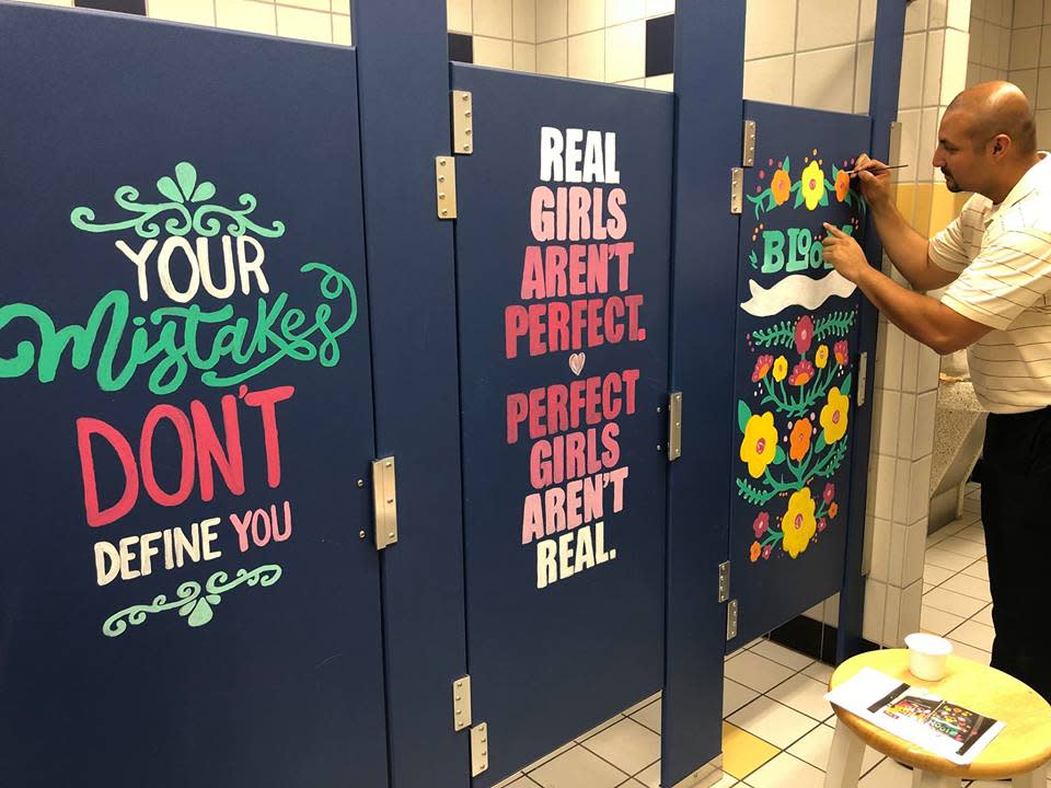 A middle school principal paints motivational murals on bathroom stalls. (Photo: Facebook/Warren.MS.Warriors)