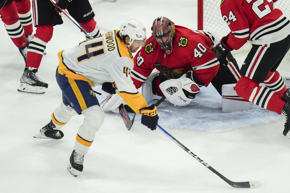 Nashville Predators left wing Kiefer Sherwood, left, scores on Chicago Blackhawks goaltender Arvid Soderblom during the first period of an NHL hockey game Friday, April 12, 2024, in Chicago. (AP Photo/Erin Hooley)