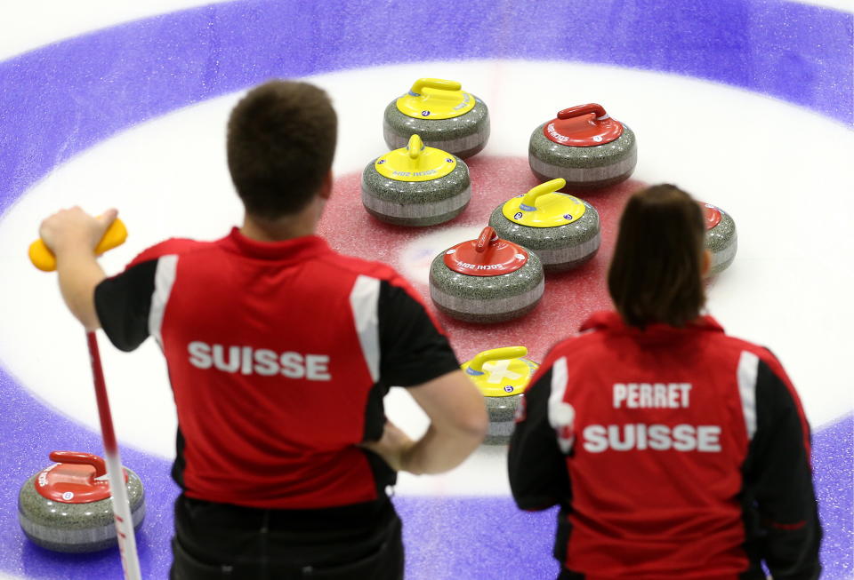 Martin Rios (L) and Jenny Perret of Team Perret (Glarus, Switzerland) in a match against Team Moskaleva (Dmitrov, Russia) at International Mixed Doubles Sochi 2017, an event of the 2017-2018 World Mixed Doubles Curling Tour, at the Ice Cube Curling Center. | Photo by Valery Sharifulin—TASS/Getty Images: