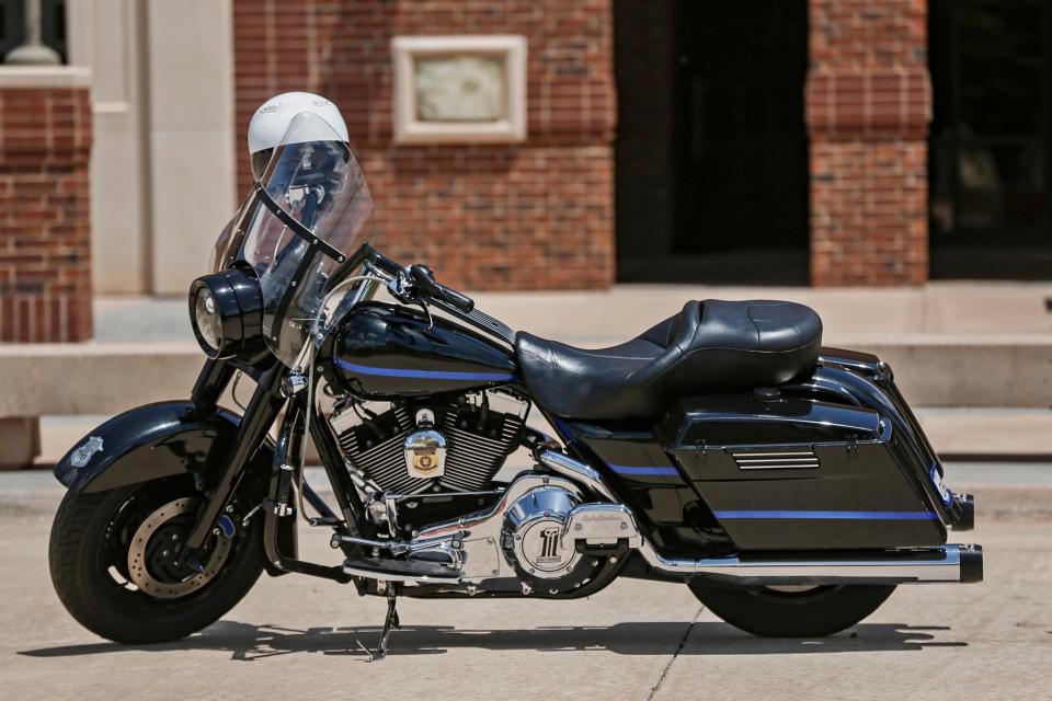 The personal motorcycle of Sgt. C.J. Nelson of the Edmond Police Department sat outside the church as the funeral for Sgt. Nelson took place at Crossings Community Church in Oklahoma City, Okla. on Monday, July 25, 2022. A fellow officer was given permission from the Nelson family to drive it to the funeral after Sgt. Nelson was killed in a multi-vehicle accident on July 19.