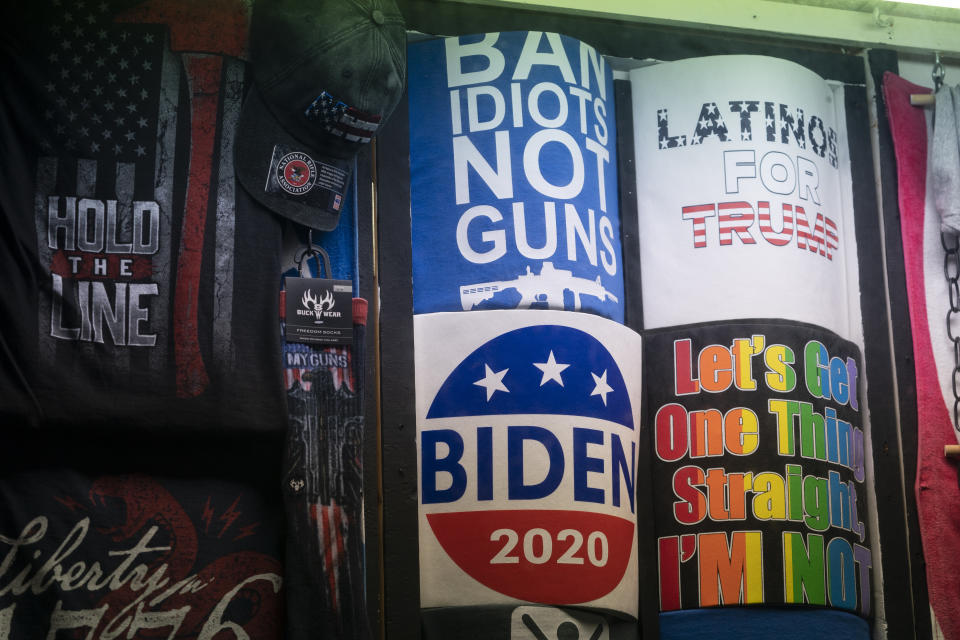 T-shirts in support of President-elect Joe Biden and President Trump are on display at T-Shirt World, Friday, Nov. 13, 2020, in Rehoboth Beach, Del. (AP Photo/Alex Brandon)