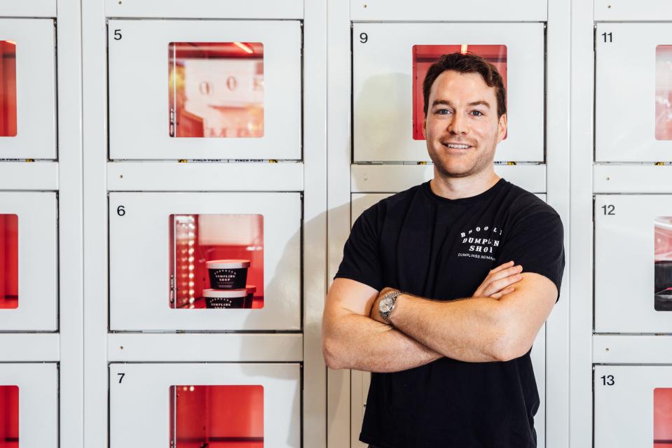 Owner and operator Alex Liebert, an Austin resident, poses with Brooklyn Dumpling Shop's locker system.