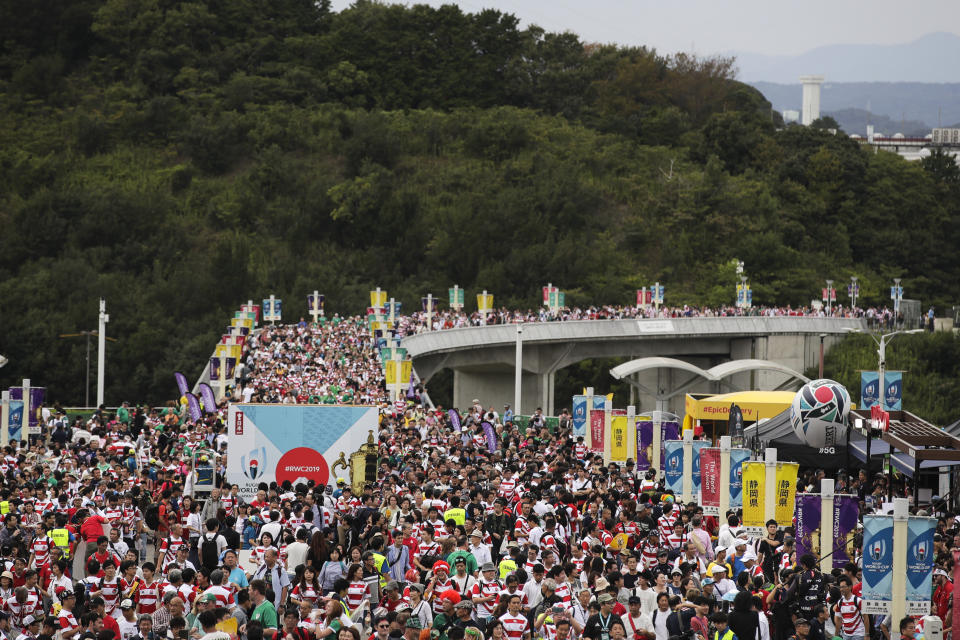 In this Sept. 28, 2019, file photo, a sea of people arrive at Shizuoka Stadium Ecopa for the Rugby World Cup Pool A game between Japan and Ireland in Shizuoka, Japan. Rugby World Cup organizers have had to cancel two games scheduled for Saturday because of concerns over the anticipated impact of Typhoon Hagibis.(AP Photo/Jae C. Hong, File)