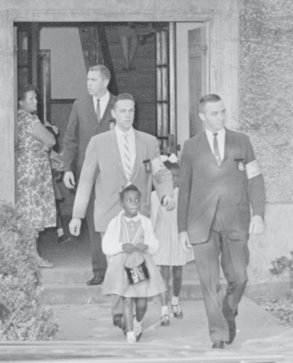 <span class="caption">Federal marshals escort three Black girls from the previously all-white McDonogh 19 Elementary School on Nov. 15, 1960.</span> <span class="attribution"><a class="link " href="https://www.gettyimages.com/detail/news-photo/three-african-american-girls-leave-the-previously-all-white-news-photo/515280276?adppopup=true" rel="nofollow noopener" target="_blank" data-ylk="slk:Bettmann/GettyImages;elm:context_link;itc:0;sec:content-canvas">Bettmann/GettyImages</a></span>