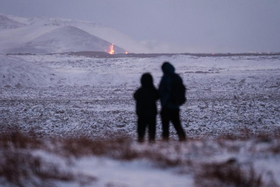 Onlookers gather to watch the lava flow after the eruption on the Reykjanes Peninsula (EPA)