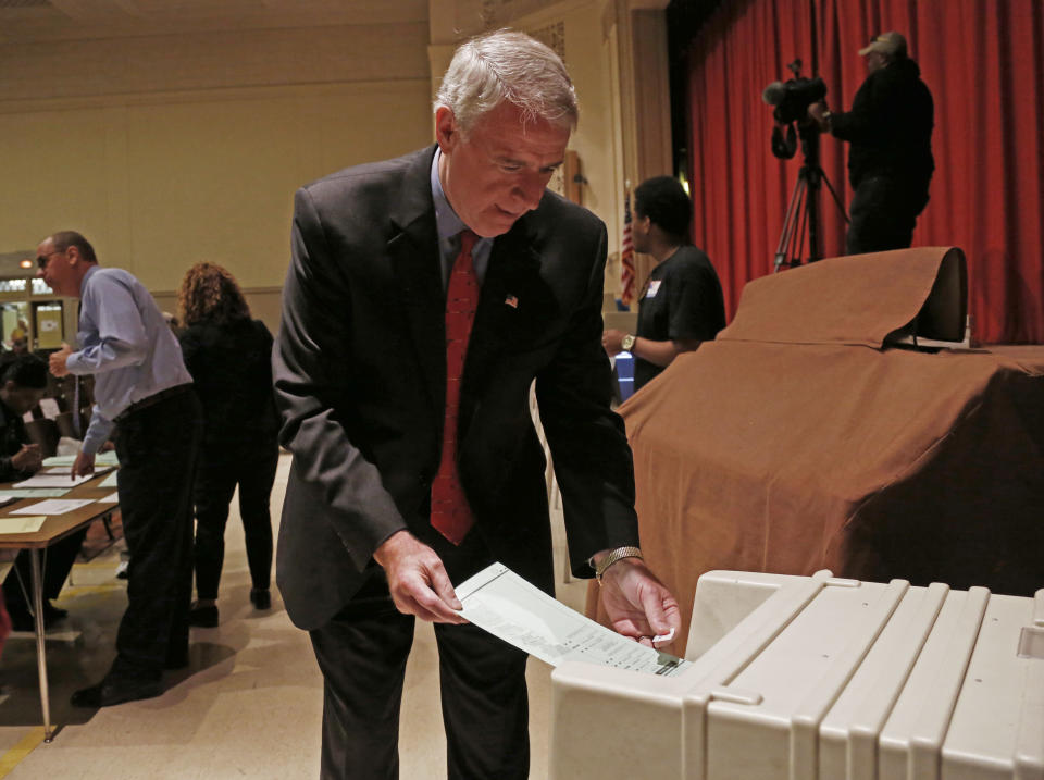 Wisconsin Democratic gubernatorial candidate Tom Barrett puts his ballot into a machine after voting Tuesday, June 5, 2012, in Milwaukee. Barrett is facing Republican Wisconsin Gov. Scott Walker in a recall election. (AP Photo/Jeffrey Phelps)