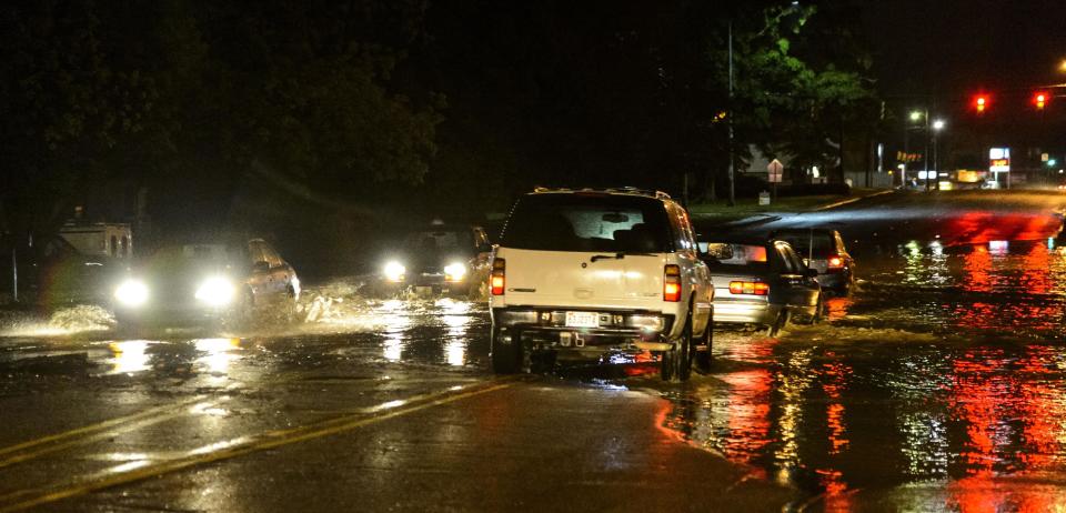 Drivers brave flooding as creek and sewer waters spill into the road, Monday, April 28, 2014, on Hargrove Road East just off of McFarland Boulevard, near the Woodlands of Tuscaloosa apartment complex in Tuscaloosa, Ala. (AP Photo/Alabama Media Group, Vasha Hunt)