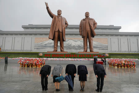 People pay their respects at the statues of North Korea founder Kim Il Sung (L) and late leader Kim Jong Il in Pyongyang, North Korea April 14, 2017. REUTERS/Damir Sagolj