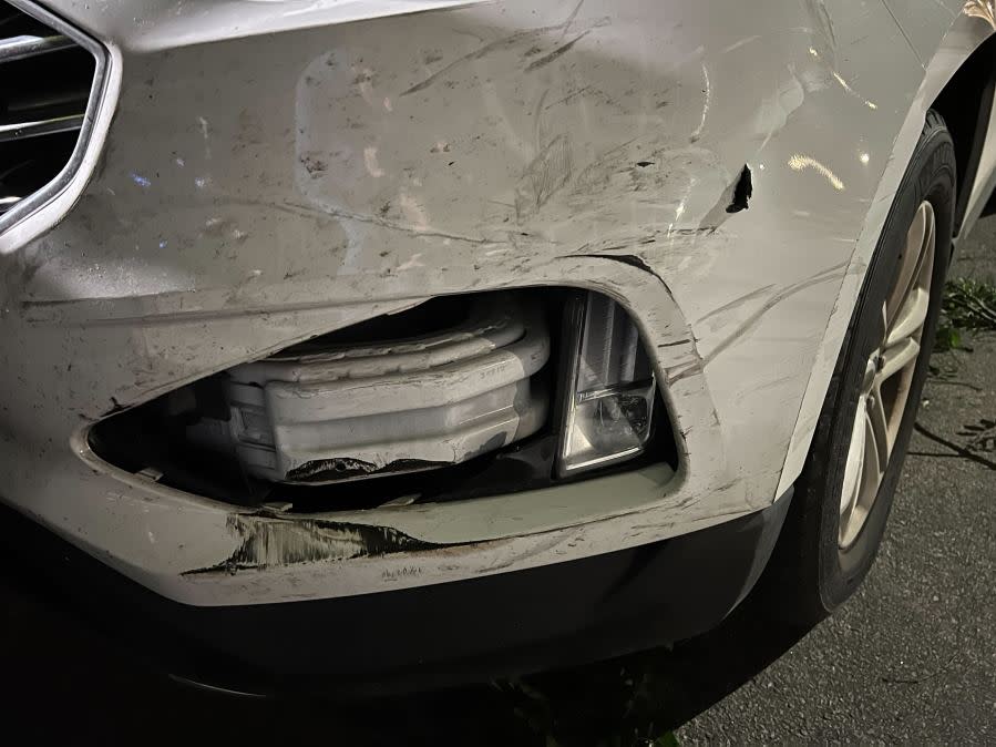 Damage to cars, street signs, etc. along East 9th Street near Embassy Drive after an 18-wheeler crashed into 10 parked vehicles overnight April 22, 2024 (KXAN Photo/Todd Bailey)