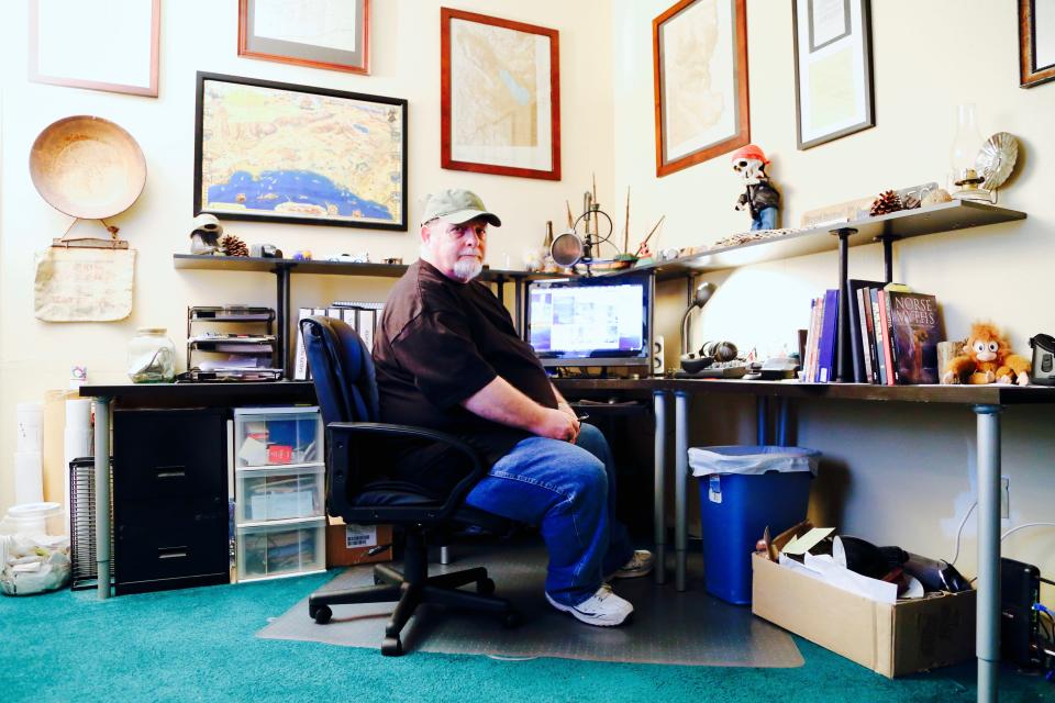 John Grasson sits at his desk in his home in Banning, Calif., where he once published "Dezert Magazine." Now, he searches for the lost ship of the desert.