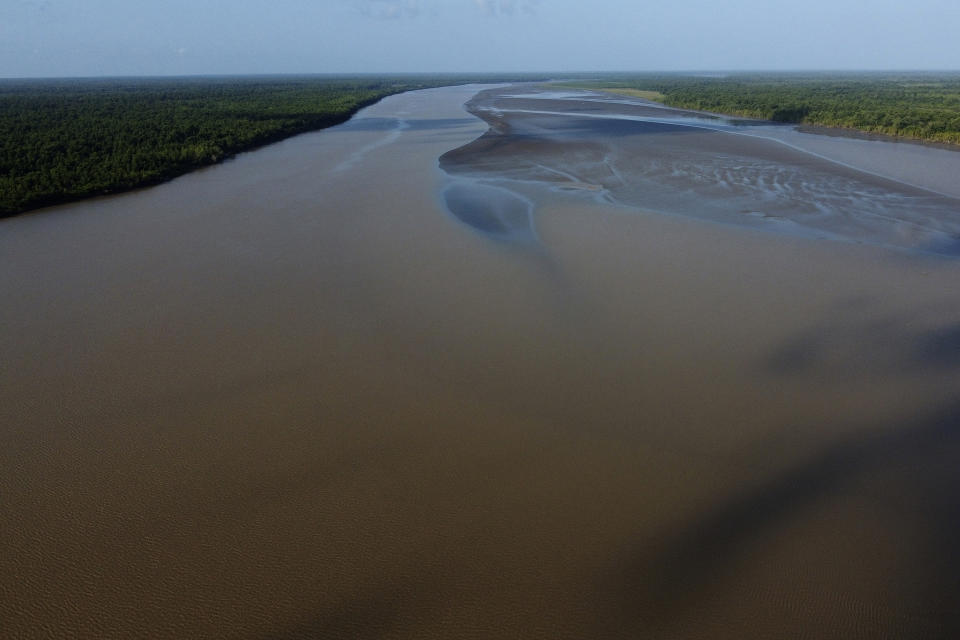 Water flows in at the point where the river meets the sea in the Bailique Archipelago, district of Macapa, state of Amapa, northern Brazil, Monday, Sept. 12, 2022. The Amazon River discharges one-fifth of all the world’s freshwater that runs off land surface. Despite that force, the seawater pushed back the river that bathes the archipelago for most of the second half of 2021, leaving thousands scrambling for drinking water. (AP Photo/Eraldo Peres)