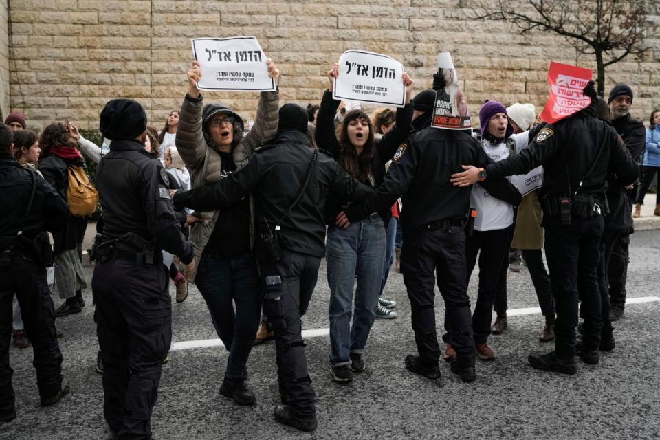 Israeli women hold banners that read ‘Time is running out’ as they demand the immediate release of the Israeli hostages held in Gaza (AP)