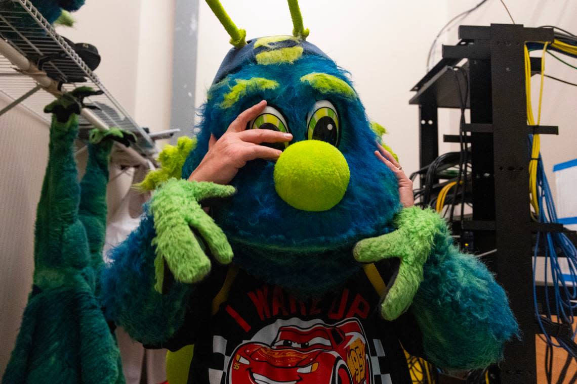 The State reporter Chris Trainor puts on the Fireflies mascot costume at Segra Park before the Fireflies play the Pelicans on Thursday, April 11, 2024. Jacob Strickland, who has performed as a mascot since he was in high school and is the current Mason, helped Trainor put on the elaborate costume.