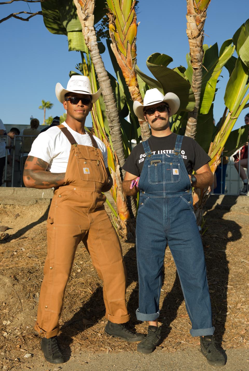 Tony, 27 and Nick, 28
“That had not crossed my mind,” says Nick, when asked if his and his festival-mate Tony’s Carhartt coveralls were inspired by Lil Nas X. “This is just real. We’re from Austin, Texas, so this is just us,” Tony concurs. A group of teens pass by and one of them shouts, “Those guys are doing it right!” (If you’re wondering, Nick’s shirt says, “Don’t Listen to Red Hot Chili Peppers.”)