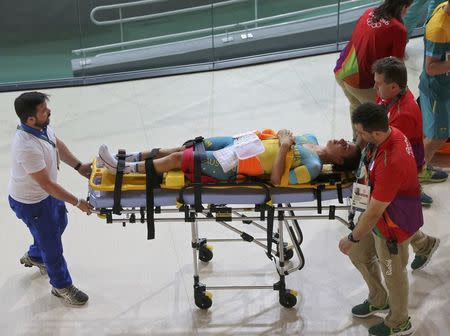 2016 Rio Olympics - Cycling Track - Preliminary - Team training - Rio Olympic Velodrome - Rio de Janeiro, Brazil - 08/08/2016. Australia's (AUS) women's team member Melissa Hoskins is aided after a crash during a practice session. REUTERS/Eric Gaillard