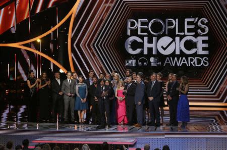 Kunal Nayyar of "The Big Bang Theory" accepts the award for favorite network TV comedy as the cast and crew stand onstage at the 2014 People's Choice Awards in Los Angeles, California January 8, 2014. REUTERS/Mario Anzuoni