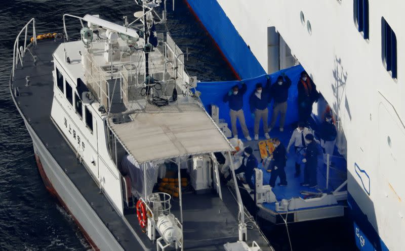 People are transferred from cruise ship Diamond Princess to a patrol ship, after ten people onboard the cruise have tested positive for coronavirus, in Yokohama