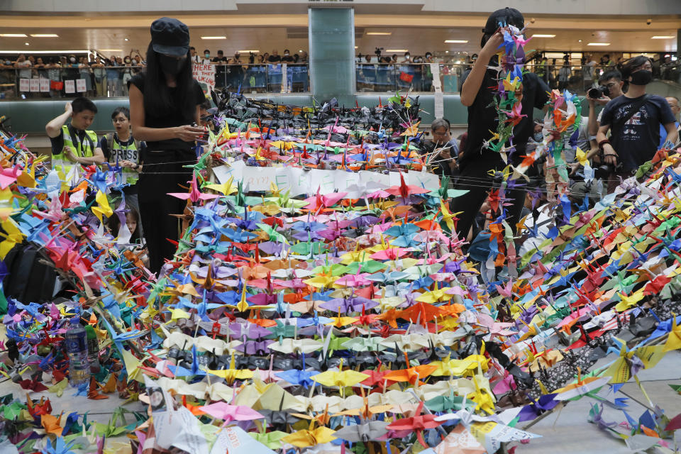 Protesters arranging origami cranes used in a display at an anti-government rally inside a shopping mall at the Sha Tin district, Sunday, Sept. 22, 2019. Protesters in Hong Kong burned a Chinese flag and police fired pepper spray Saturday in renewed clashes over grievances by the anti-government demonstrators. (AP Photo/Vincent Yu)