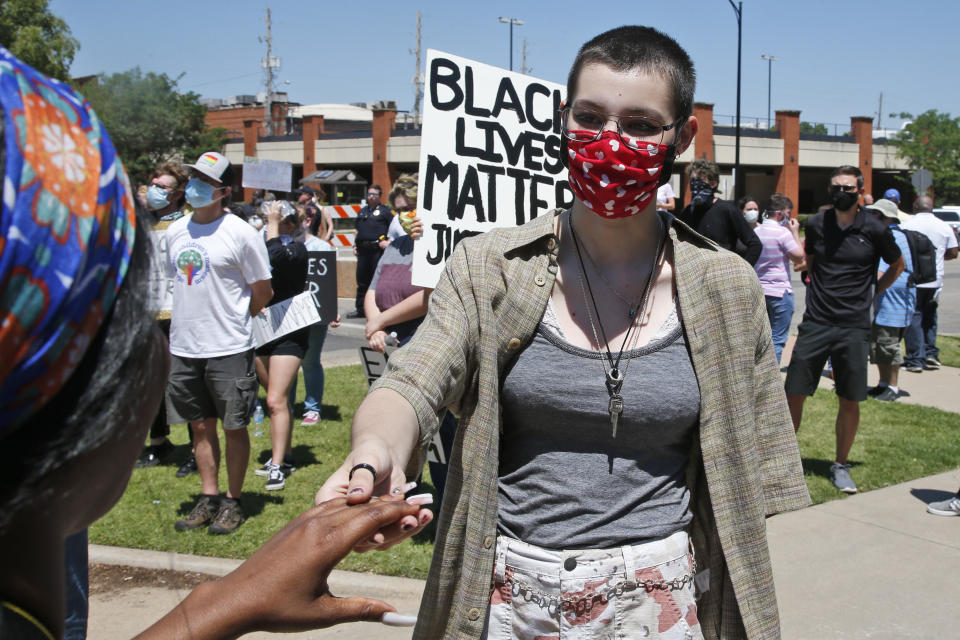 Emily Croft, 17, a student at Stillwater High School, greets a participant June 3 in Stillwater, Oklahoma, at a rally to protest the death of George Floyd. Croft organized the peaceful rally. (Photo: Sue Ogrocki/Associated Press)