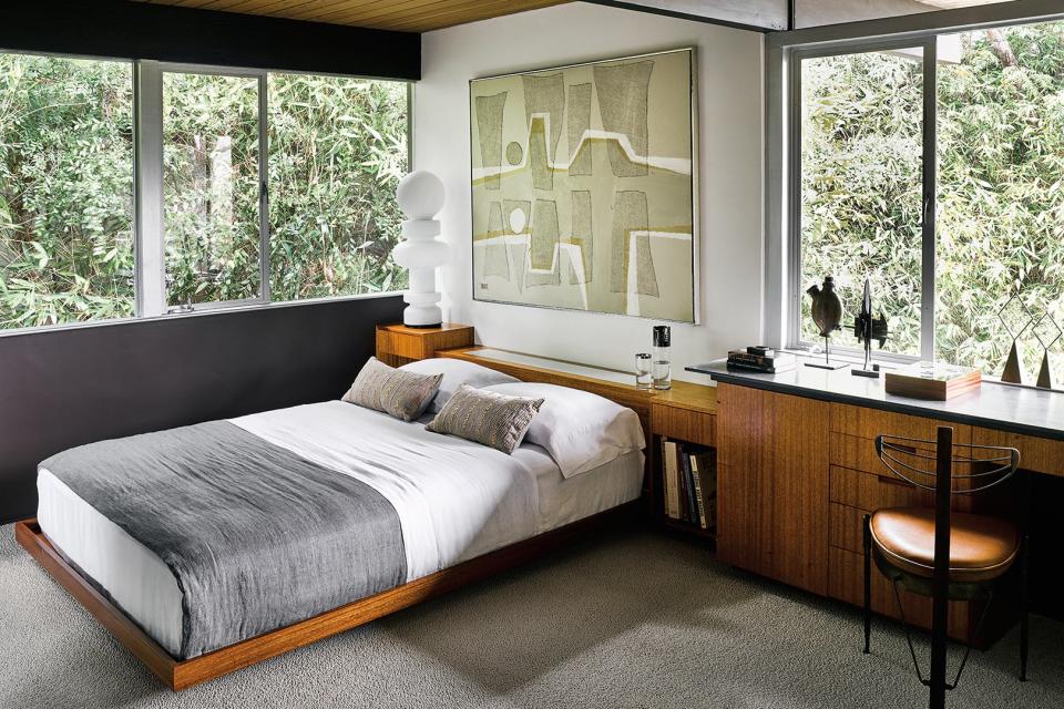 Mid-century modern bedroom with wood desk.