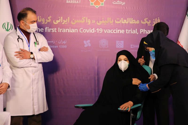 A nurse prepares to inject a volunteer taking part in an Iranian coronavirus disease (COVID-19) vaccine trial in Tehran