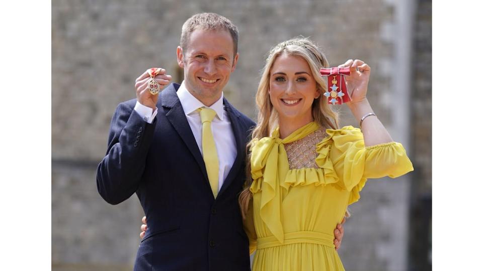 Dame Laura Kenny poses after she received her Dame Commander medal and Sir Jason Kenny poses after he received his Knight Bachelor medal awarded by the Duke of Cambridge during an investiture ceremony at Windsor Castle on May 17, 2022 in Windsor, England