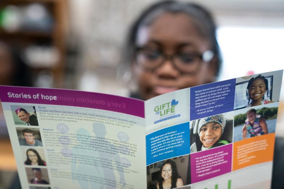 Jelisa Bargainer, 17, of Detroit, looks through the Gift of Life brochure about organ donation as the organization's community relations coordinator Taneisha Carswell, 41, of Macomb, speaks to seniors in a biology class at Renaissance High School in Detroit on Tuesday, Jan. 30, 2024.
