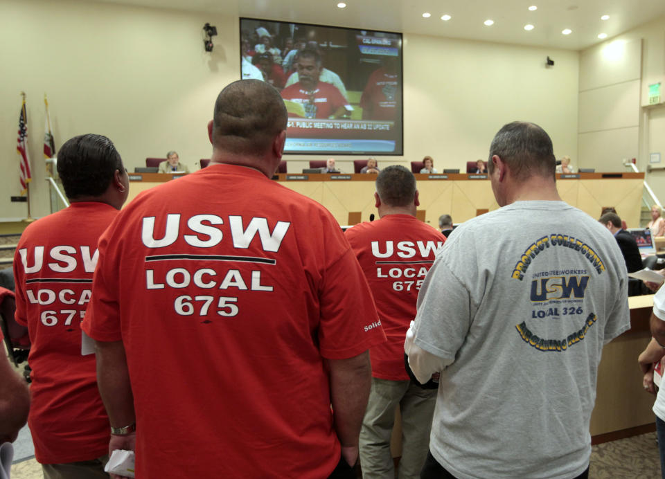 Members of the United Steel Workers in joined dozens of others calling for the California Air Resources Board to reconsider the state's pending cap-and-trade program for carbon emissions, during a hearing Thursday, Sept. 20, 2012, in Sacramento, Calif. The board took testimony from experts and the public on the the cost to businesses and consumers with the implementation of AB32, California's landmark greenhouse gas emissions law. (AP Photo/Rich Pedroncelli)