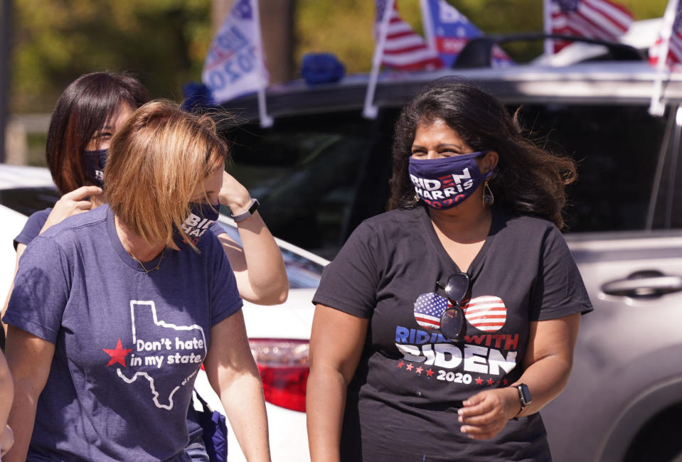 A Supporter of Democratic presidential candidate former Vice President Joe Biden chat before a Ridin' With Biden event Sunday, Oct. 11, 2020, in Plano, Texas. Democrats in Texas are pressing Joe Biden to make a harder run at Texas with less than three weeks until Election Day. (AP Photo/LM Otero)