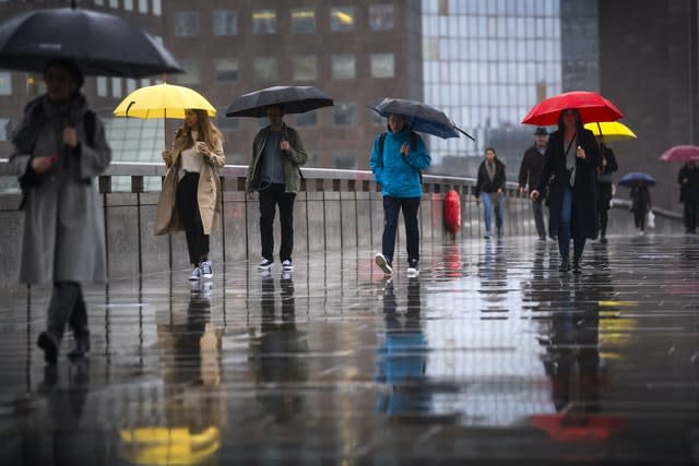 Morning commuters cross London Bridge