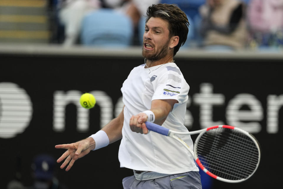 Cameron Norrie of Britain hits a forehand return to Alexander Zverev of Germany during their fourth round match at the Australian Open tennis championships at Melbourne Park, Melbourne, Australia, Monday, Jan. 22, 2024. (AP Photo/Alessandra Tarantino)