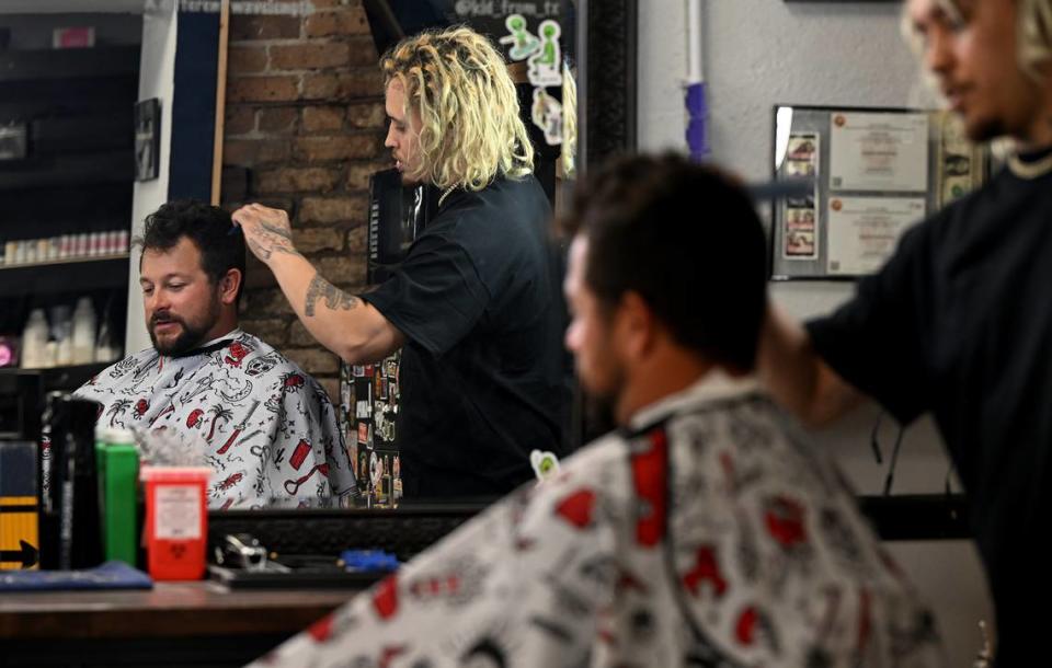 Jeff Leonard, a fishing boat captain, gets his hair cut by Chris Urdiales at the Oxford Barbershop in downtown Bradenton.