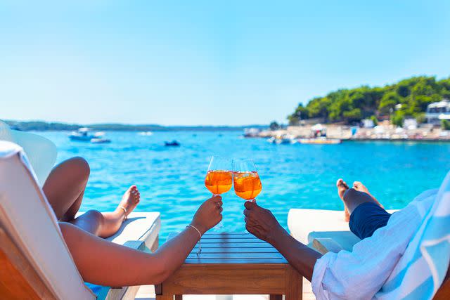 <p>Getty</p> A stock photo of a couple relaxing by the water