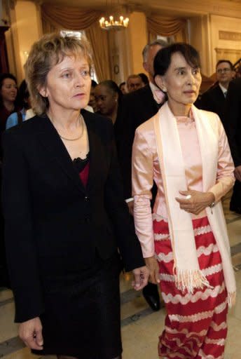 Swiss President Eveline Widmer-Schlumpf (L) stands next to Myanmar opposition leader Aung San Suu Kyi during a reception in Bern