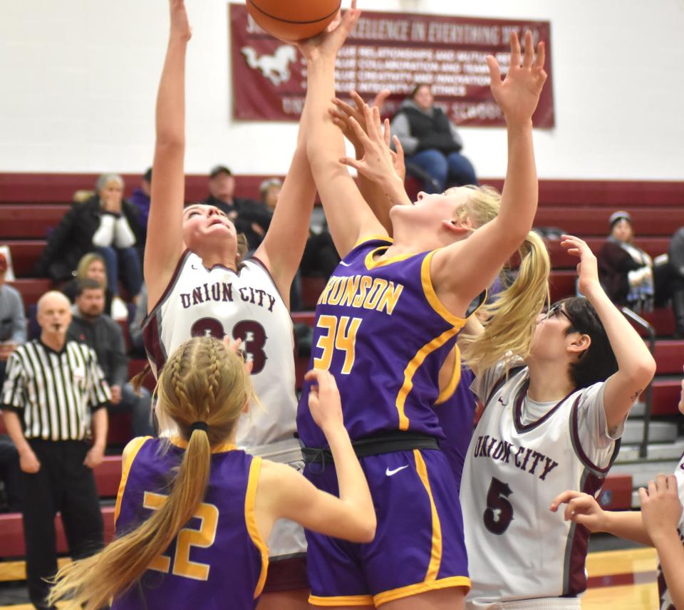 Bronson's Payton Springstead (34) battles Union City's Gracie Phelps (23) for a rebound while Bronson's Ashlynn Harris (22) and Union City's Aaleya Asher (5) look on