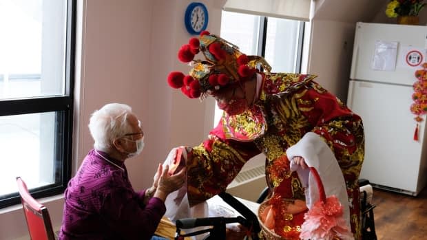 A resident at Mon Sheong Home for the Aged takes part in a Chinese New Year celebration in Toronto in February 2021. (Submitted by Mon Sheong Foundation - image credit)