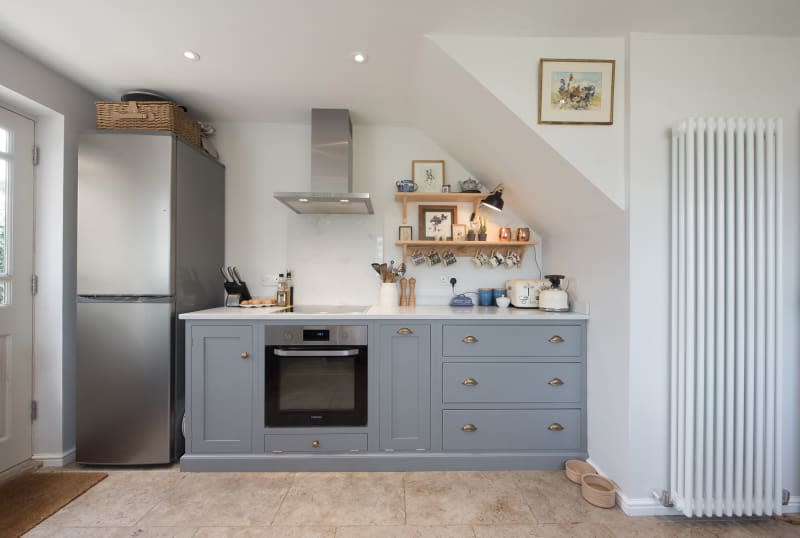 A general interior view of a shaker style kitchen with grey cabinets and units