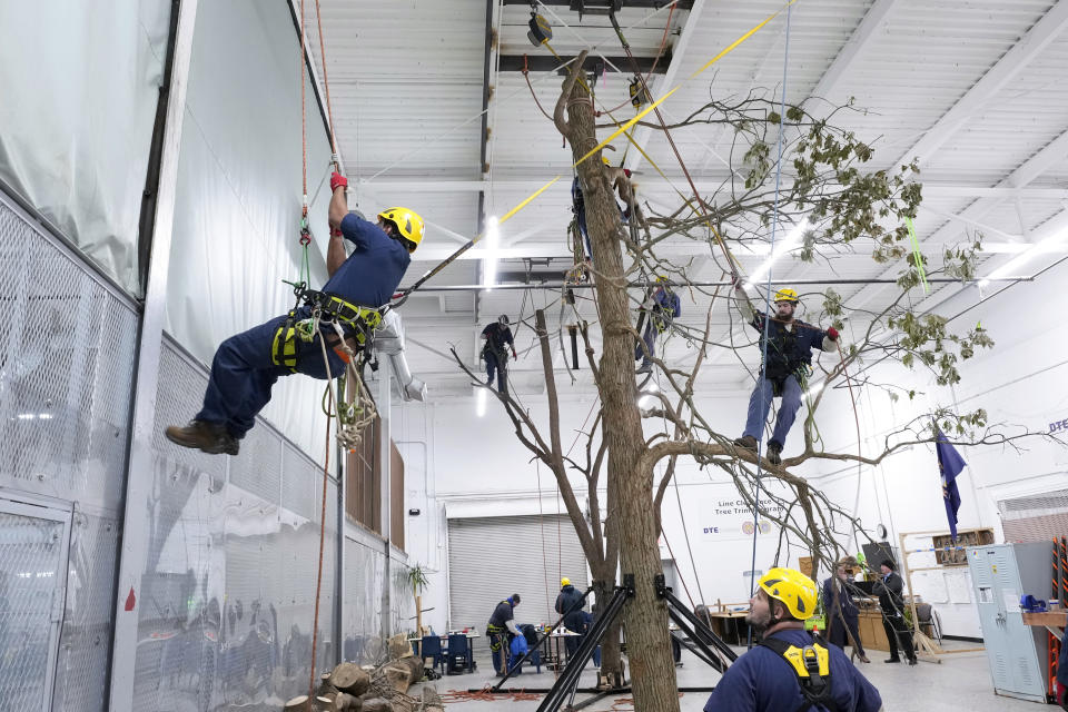 Prisoners work on climbing indoor at the Parnall Correctional Facility's Vocational Village in Jackson, Mich., Thursday, Dec. 1, 2022. More than a dozen prisoners are learning how to climb trees and trim branches around power lines as part of DTE Energy's plan to improve the utility's electric infrastructure. (AP Photo/Paul Sancya)