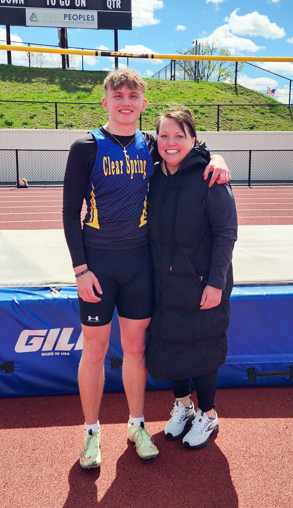 Clear Spring junior Jacob Faith and mother Jenny Faith stand in front of the high jump pit at Greenway Avenue Stadium in Cumberland, where Jacob Faith won the Fort Hill Invitational boys high jump title with a personal-record leap of 6 feet, 6 inches on April 13.