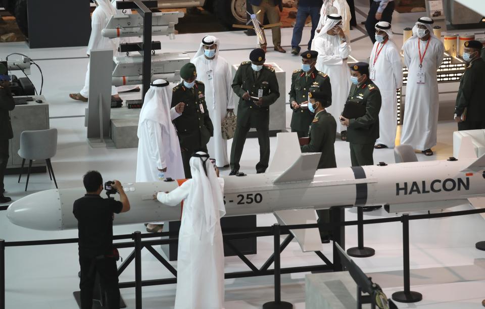 A military delegation visit the display of Halcon, a regional leader in the end-to-end manufacturing of precision-guided systems, during the opening day of the International Defence Exhibition & Conference, IDEX, in Abu Dhabi, United Arab Emirates, Sunday, Feb. 21, 2021. (AP Photo/Kamran Jebreili)