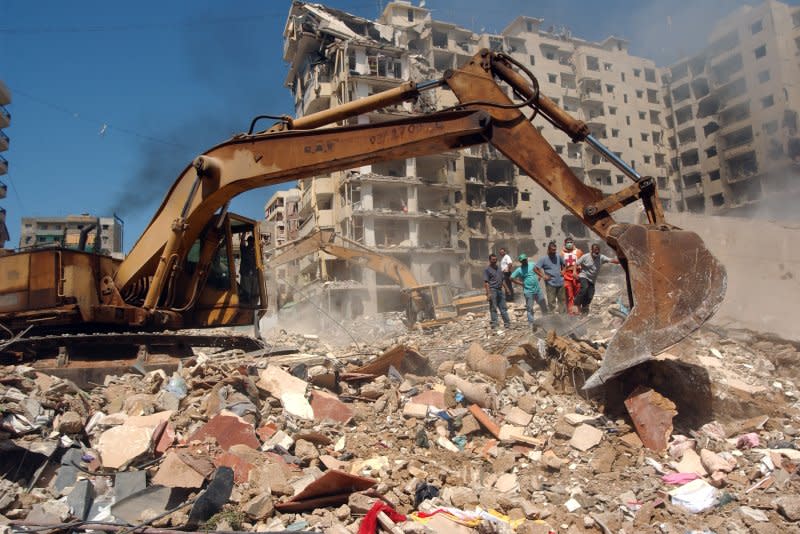 Lebanese rescue crews dig through the rubble of numerous apartment blocks in Beirut's southern suburbs which were flattened by Israeli missiles hours before a U.N. brokered cease-fire went into effect on August 14, 2006. File Photo by Norbert Schiller/UPI