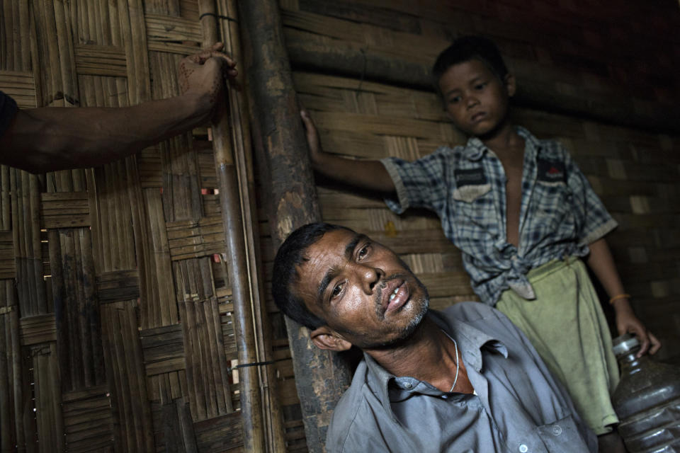 SITTWE, BURMA - MAY 06: Ya Kup, 44, sits in his hut, barely able to hold himself upright. Due to vomiting and fever he is unable to eat and cannot work on May 6, 2014 in Sittwe, Burma. Some 150,000 Rohingya IDP (internally displaced people) are currently imprisoned in refugee camps outside of Sittwe in Rakhine State in Western Myanmar. Medecins Sans Frontieres (MSF), the primary supplier of medical care within the camps, was banned in March by the Myanmar government. Follow up attacks by Buddhist mobs on the homes of aid workers in Sittwe put an end to NGO operations in the camps. Though some NGOs are beginning to resume work, MSF remains banned, and little to no healthcare is being provided to most Rohingya IDPs. One Rohingya doctor is servicing 150,000 refugees with limited medication. Several Rakhine volunteer doctors sporadically enter the camps for two hours a day. Births are the most complicated procedures successfully carried out in the camps, requests to visit Yangon or Sittwe hospitals for life threatening situations require lengthy applications and are routinely denied. Malnutrition and diarrhea are the most widespread issues, but more serious diseases like tuberculosis are going untreated and could lead to the rise of drug resistant tuberculosis (DR-TB).  (Photo by Andre Malerba/Getty Images)