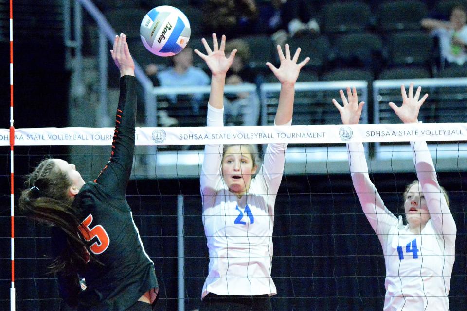 Sioux Falls O'Gorman's Makenzie Walsh (21) and Keira McManus defend at the net against Huron's Isabelle Ellwein during their first-round Class AA match in the state high school volleyball tournament on Thursday, Nov. 17, 2022 in the Denny Sanford PREMIER Center.